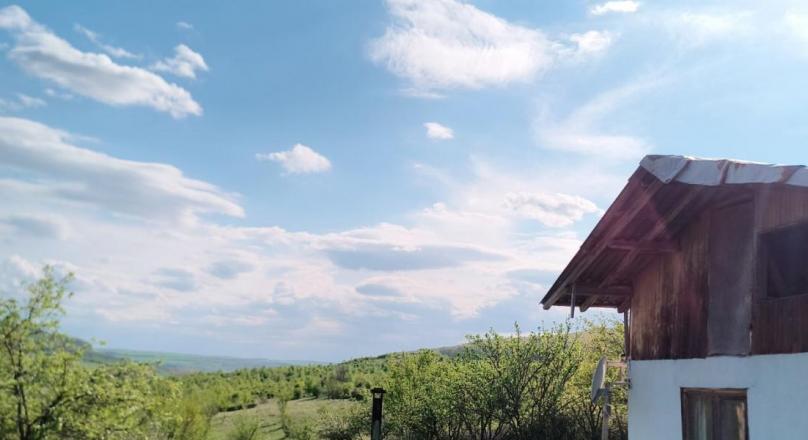 a small paradise in the middle of a field and hills
