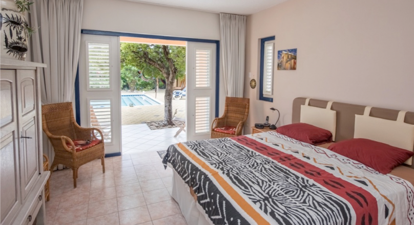 A spacious two-floor villa with large pool and palapa.