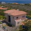 A spacious two-floor villa with large pool and palapa.