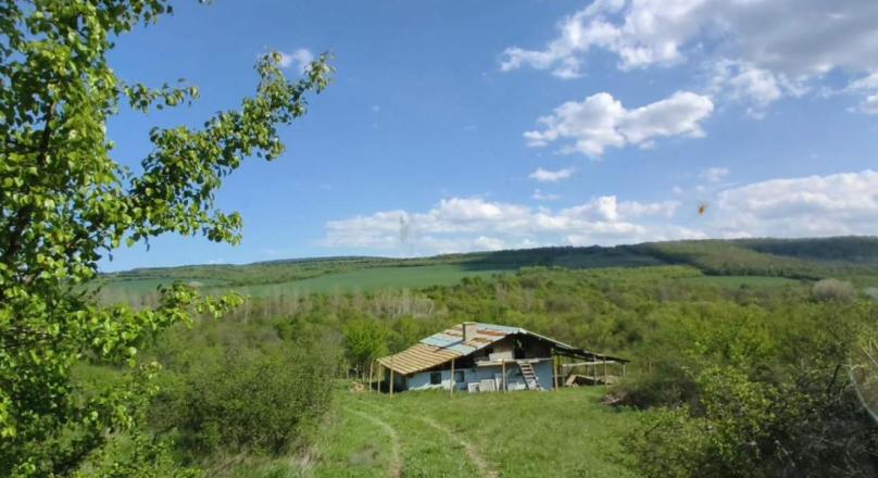 a small paradise in the middle of a field and hills