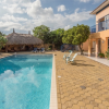 A spacious two-floor villa with large pool and palapa.